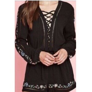 Black Romper with embroidered flowers details.